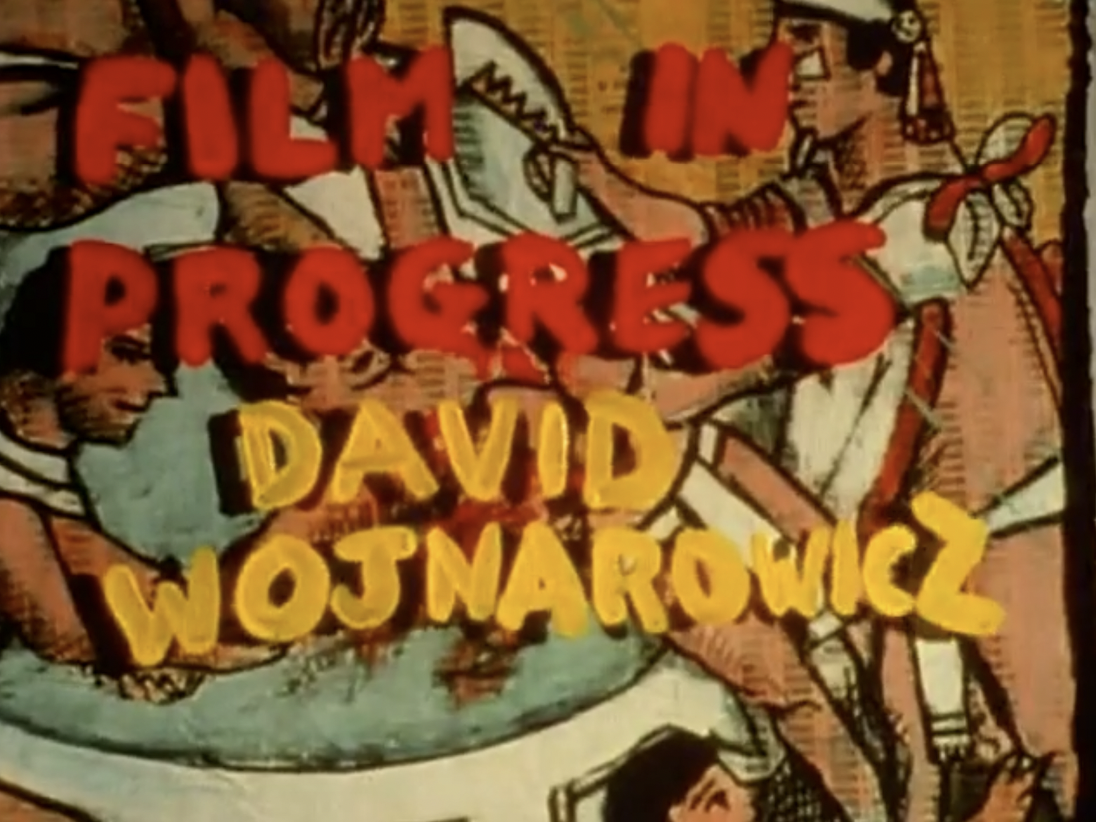 Still from A Fire In My Belly (1986-87). Handwritten text in red paint reads "FILM IN PROGRESS,"